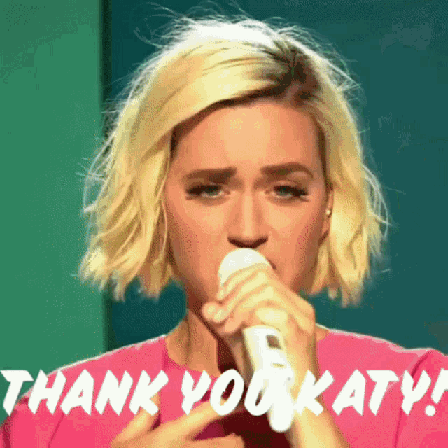 a woman singing into a microphone with the words thank you katy written above her
