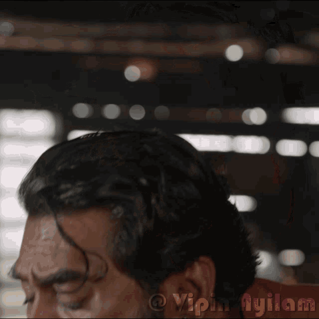 a close up of a man 's face with the words vipin ayilam below it