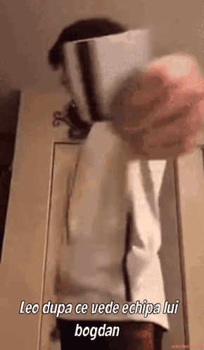 a person is standing in front of a door with the words leo dupa ce vede echipa lui bogdan written on the bottom