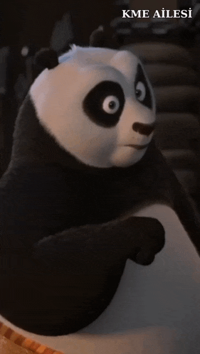 a black and white panda bear with kme ailesi written on the bottom right