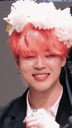 a man with red hair and a flower crown on his head