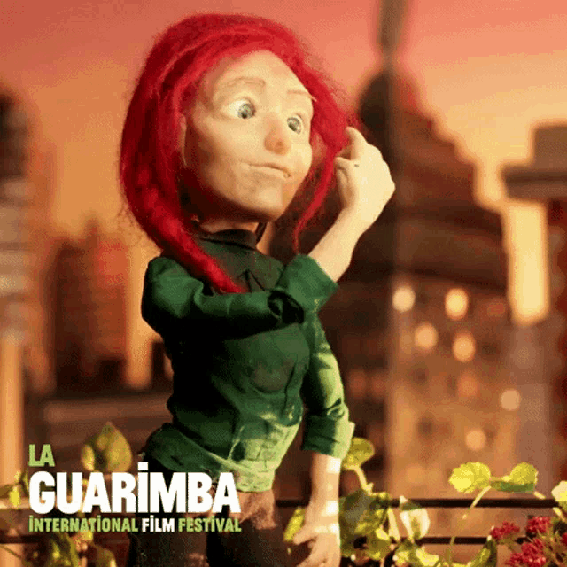 a doll with red hair is standing in front of a sign for la guarimba international film festival
