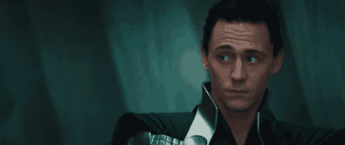 a close up of a man 's face with a serious look on his face in a dark room .