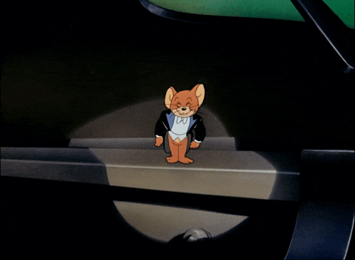 a cartoon of jerry wearing a tuxedo and bow tie is standing in a dark room