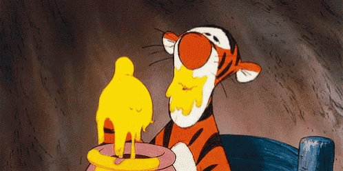 tigger from winnie the pooh is eating honey from a pitcher
