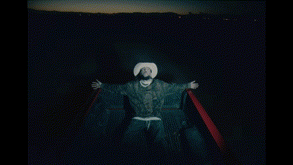 a man in a cowboy hat is sitting in a boat with his arms outstretched .
