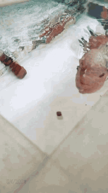 a person is laying in a bathtub with a reflection of a person in the water