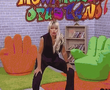 a pixelated image of a woman squatting in front of a wall that says ' orchestra ' on it