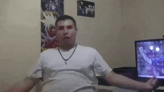 a man is dancing in front of a television in a room