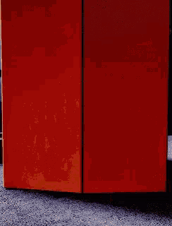 an orange box is sitting on a carpeted floor