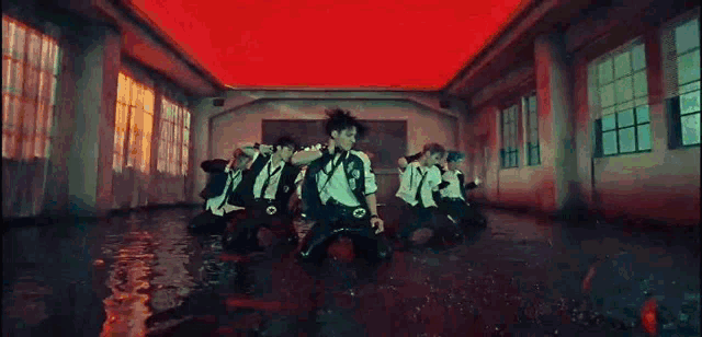 a group of people are dancing in a flooded room in a classroom .