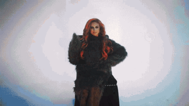 a woman with red hair is standing in a fur coat