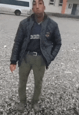 a man wearing a black jacket with a patch that says ' a ' on it