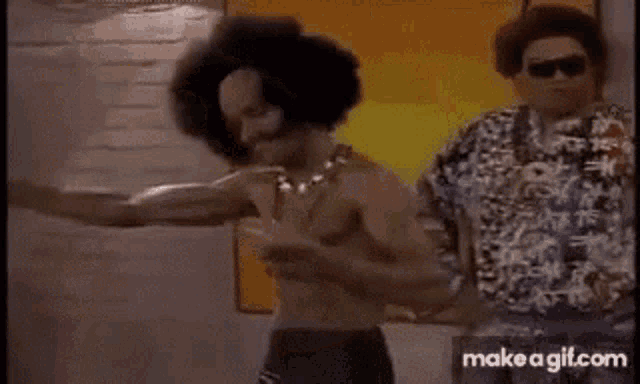a shirtless man with curly hair is dancing in a room .