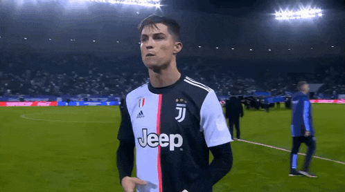 a soccer player wearing a jeep jersey stands on a field