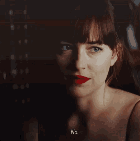 a close up of a woman 's face with red lipstick and the words `` no '' written below her .