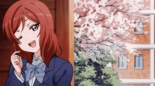 a girl with red hair is standing in front of a building with cherry blossoms