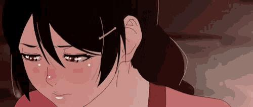 a close up of a girl with tears running down her face .
