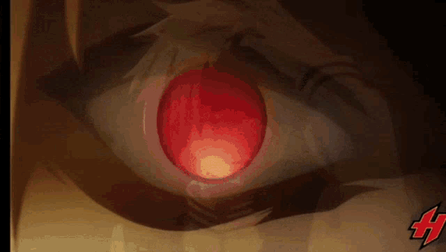 a closeup of a person 's eye with a red pupil