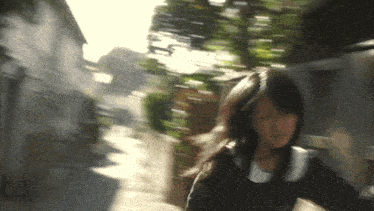a blurry picture of a girl walking down the street