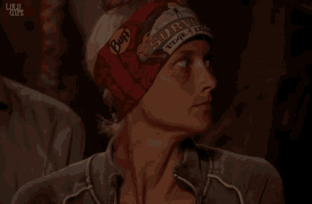 a woman wearing a red headband that says survivor