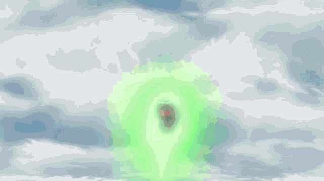 a man in a green hoodie is flying through the air .
