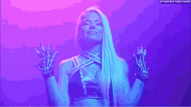 a female wrestler is wearing a black top and skeleton gloves in a dark room