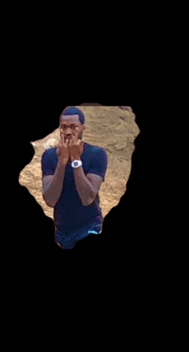 a man wearing a black shirt and a white watch is making a middle finger gesture