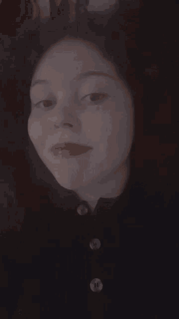 a woman with red lips and a ring on her finger