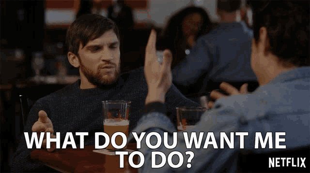 a man sitting at a table talking to another man with the words what do you want me to do on the bottom