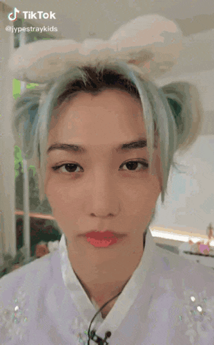 a close up of a person 's face with blue hair