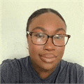 a woman wearing glasses is smiling for the camera .