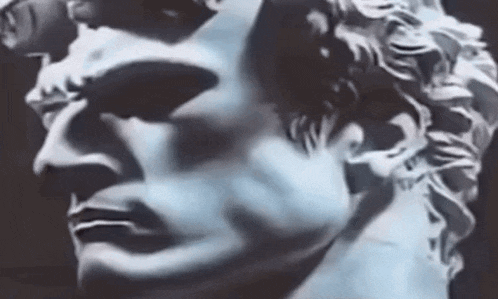 a close up of a statue of a man 's head on a black background