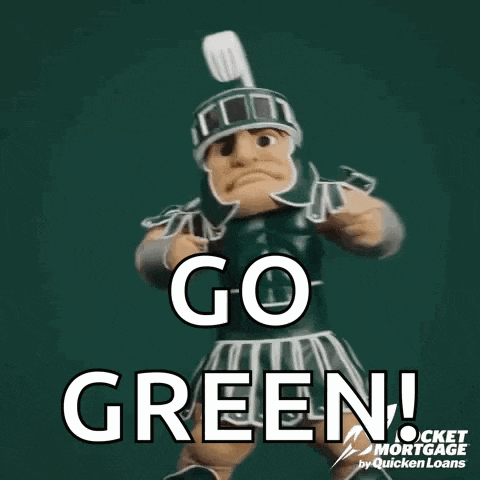 a mascot is standing in front of a sign that says go green