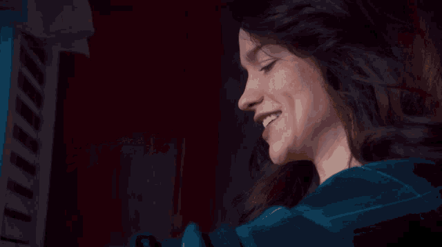 a woman in a blue plaid shirt is smiling with the words success behind her