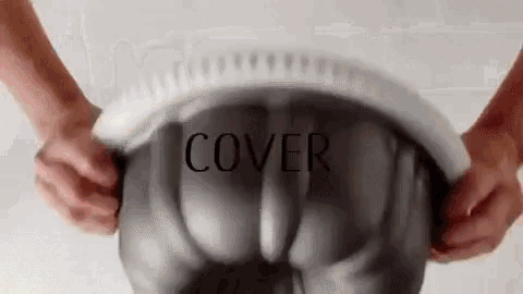 a person is holding a cake pan with a white cover .