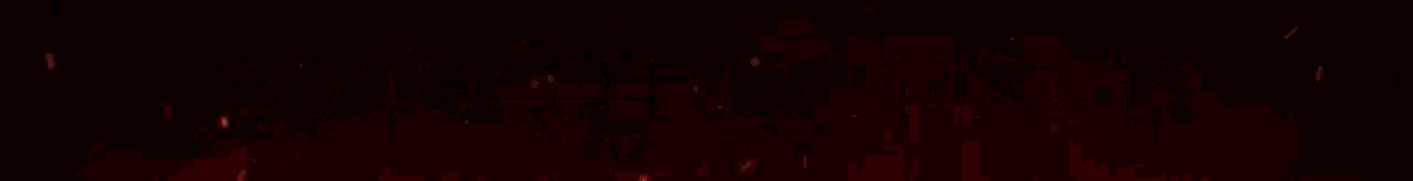 a red light beam is coming out of a hole in a dark room .