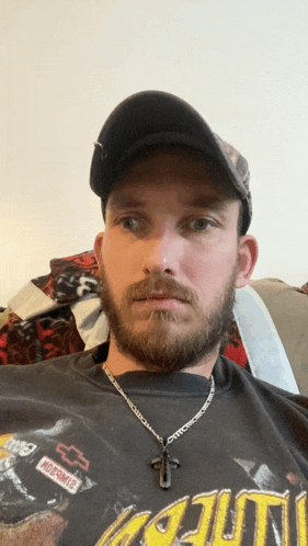 a man with a beard wearing a hat and a chevrolet patch