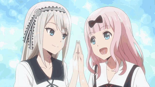 a couple of anime girls standing next to each other with their hands together