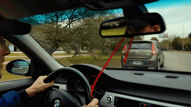 a man is driving a bmw with a license plate that says yc - 912