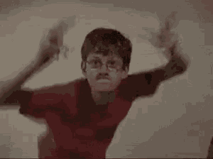 two young boys are dancing together in a room .