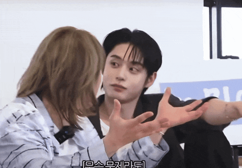 a man with a ring on his finger talks to a woman