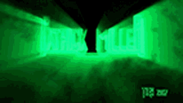 a green light is shining in a dark room with the word war on it