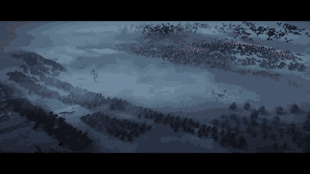 a large flock of birds flying over a snow covered field