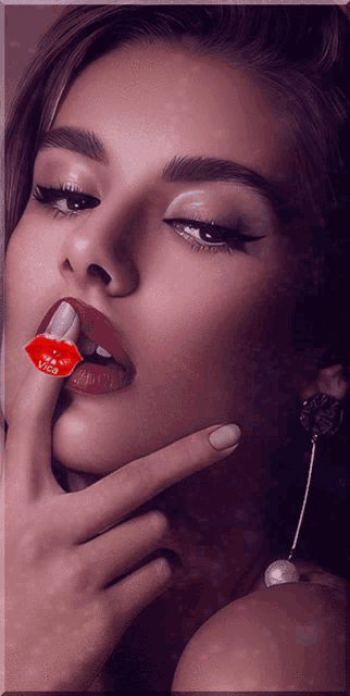 a woman with red lips and a kiss on her ring finger