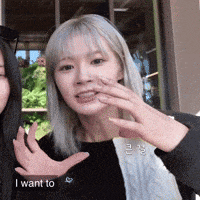 a woman with white hair is making a gesture with her hands and says i want to