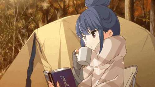 a girl is sitting in front of a tent reading a book while drinking a cup of coffee .
