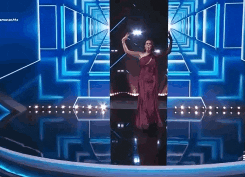 a woman in a red dress is on a stage