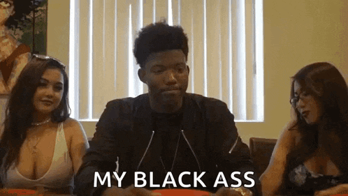 a man and two women are sitting at a table and the man is saying my black ass .