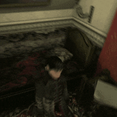 a blurry picture of a man in a suit and tie in a bedroom
